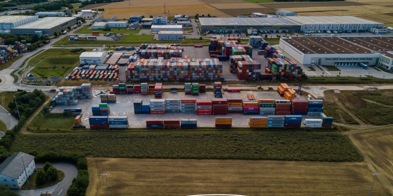 Luftansicht des bimodalen Containerterminals im GVZ Region Ulm mit Kränen und Güterzügen.